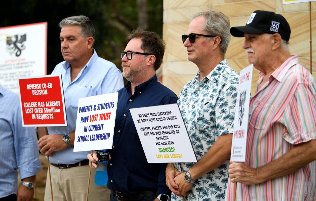 Parents and old scholars hold placards during a protest against Newington College's decision to transition to co-ed, in Sydney, Wednesday, January 31, 2024. Picture AAP Image/Bianca De Marchi