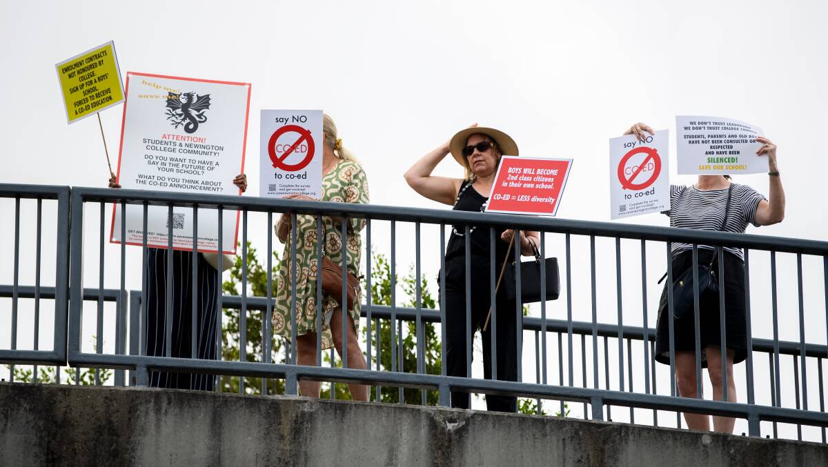 Parents and old scholars hold placards during a protest against Newington College's decision to transition to co-ed, in Sydney, Wednesday, January 31, 2024. Picture AAP Image/Bianca De Marchi