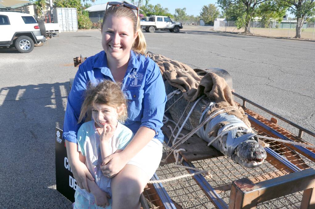 Stacey and Charli Kessner with the big male croc which dad first spotted while fishing at Timber Creek on the weekend.