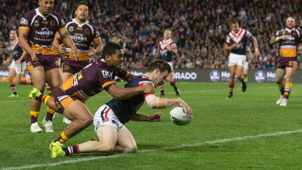 Grounded: Luke Keary beats the tackle of Anthony Milford to score. Photo: AAP