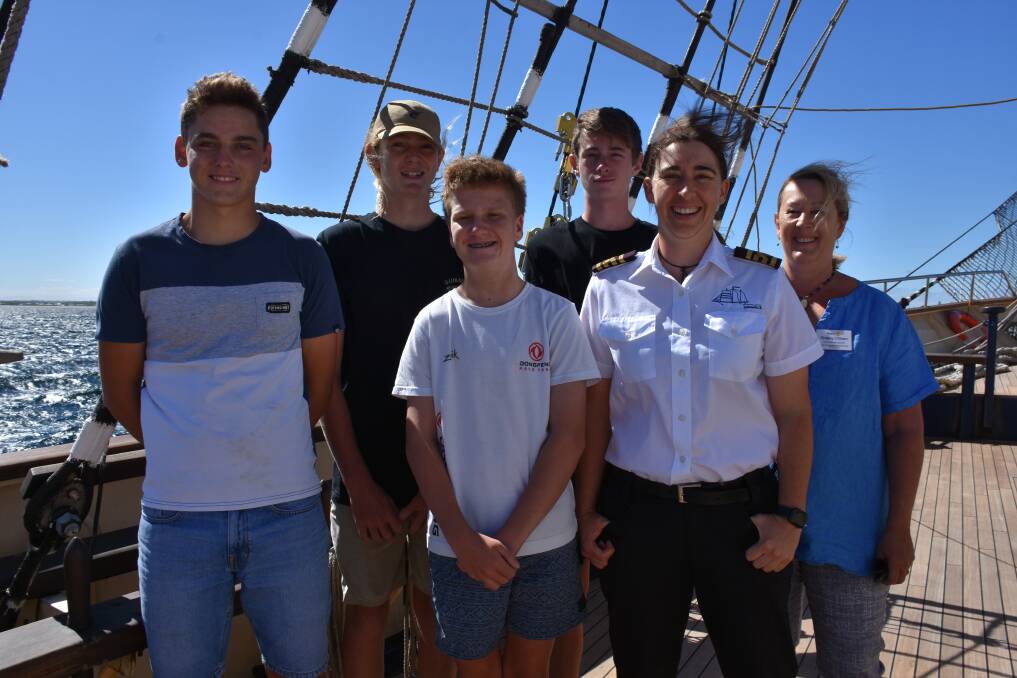 James Newton, Luke Reynolds, Xavier Bains, and Tiernan Bass with Captain Angela Lewis and Rotary Club member Shelley O'Brien on board the STS Leeuwin II.