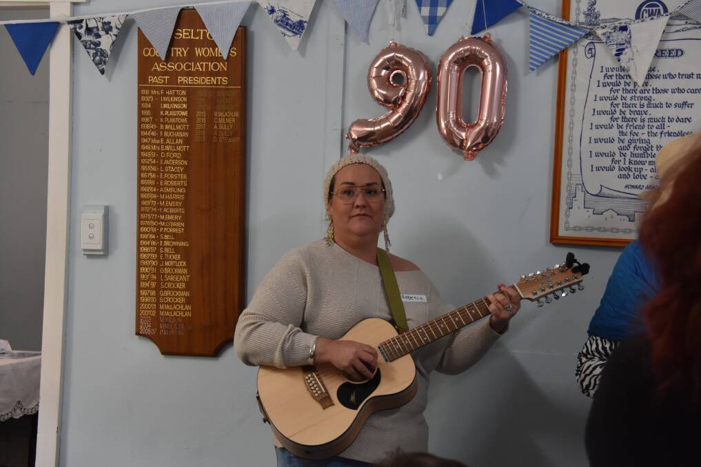 Rebecca Bryen entertains guests at the 90th anniversary of the CWA's Busselton branch.
