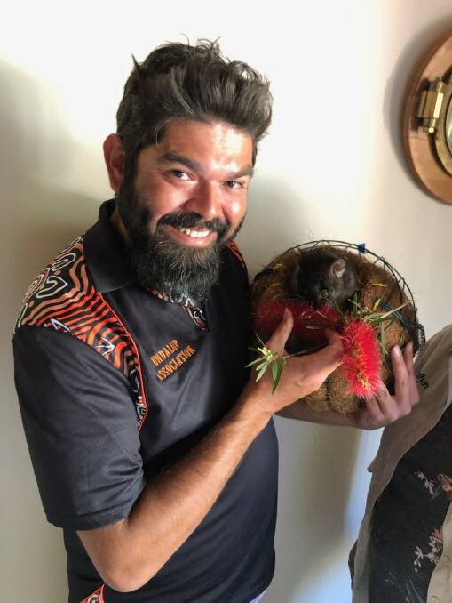 Zac Webb with Ngarri (Beautiful) which was one of the critically endangered western ringtail possums which were released into the wild as part of the Possum School program.