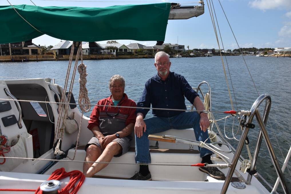 Geographe Bay Yacht Club commodore Barry McLennan and social sailing organiser Gavin Sorrell are stuck inside the marina walls as wrack buildup prevents keel boats from exiting or entering Port Geographe..