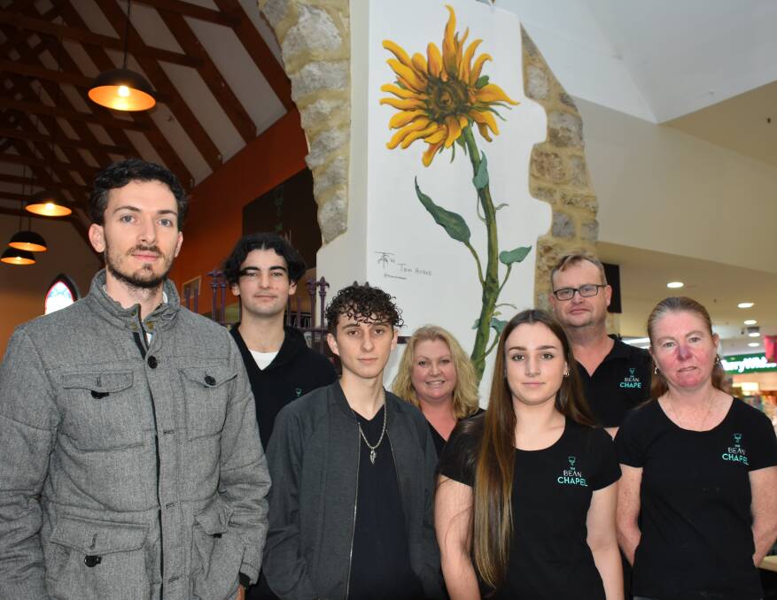 Artist Tom Ansell and the team at the Bean Chapel Cafe in Busselton celebrate the building's past with a sunflower mural in recognition of a time gone by.