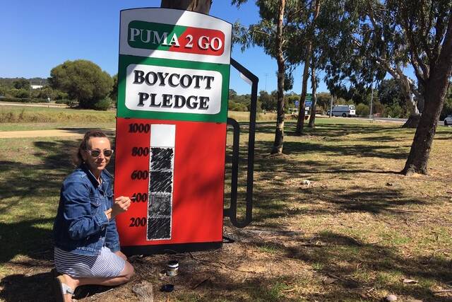 Dunsborough resident Trish Flower counts over 800 pledges to boycott a proposed Puma Energy petrol station in Dunsborough's town centre. Image supplied.