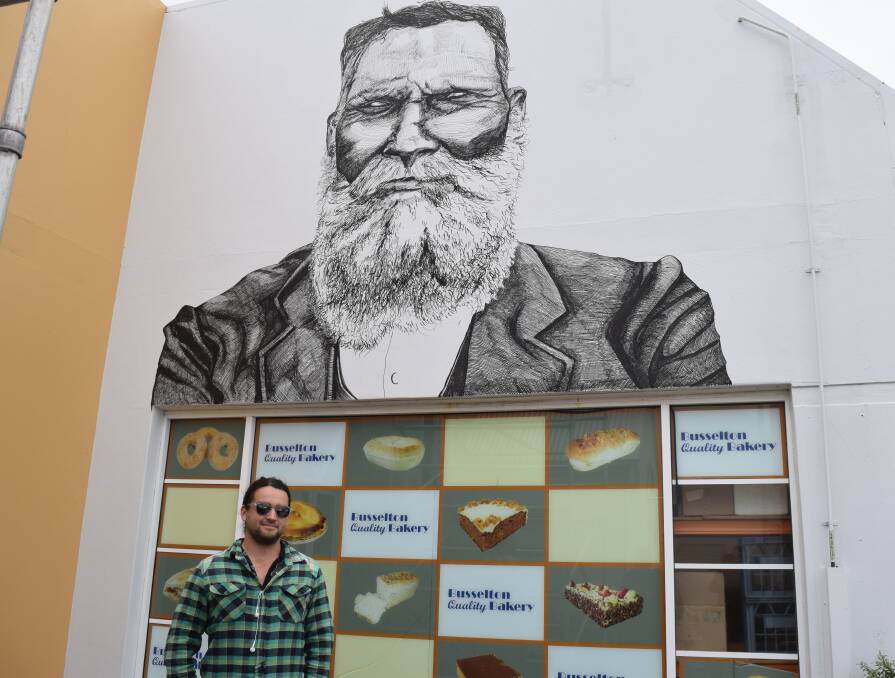 Busselton artist Jack Bromell and his portrait of South West Aboriginal hero Sam Isaacs.