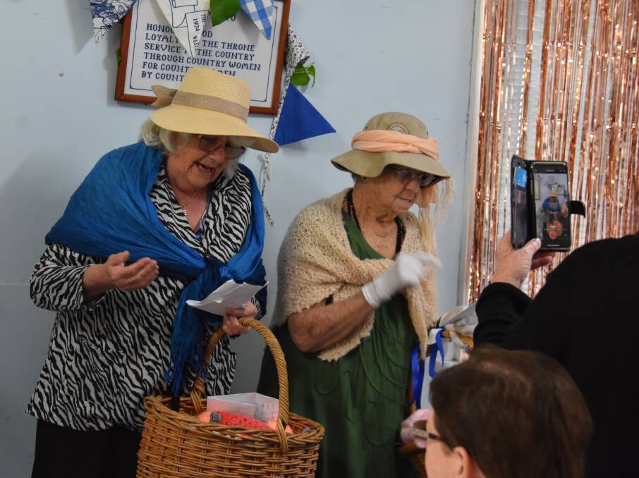 CWA Busselton branch members June Mills and Mary Fullerton entertain guests at the 90th anniversary celebration.