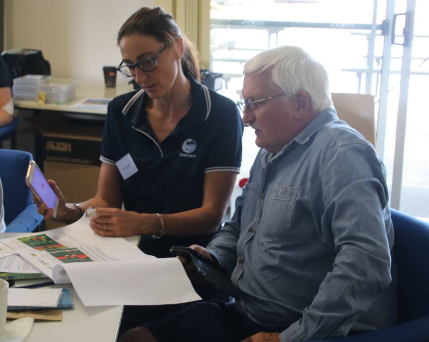 GeoCatch project officer Kim Archer helps looks through soil test results at the 2020 soil testing workshop. Image supplied.