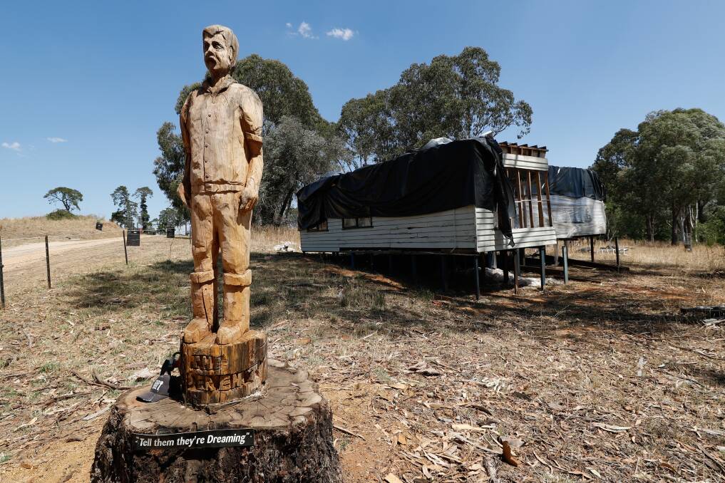 Open house: A timber carving of Darryl Kerrigan from The Castle sits in front of his fictional home at Mayday Hills on Wednesday. The house will no longer be a caravan park office after a council ruling. Picture: JAMES WILTSHIRE 