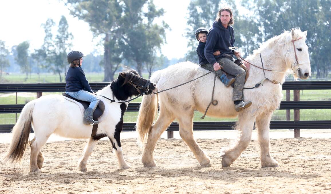 Leading horseman: Adrian Corboy at his Wangaratta horse breaking property with two of his seven children. Picture: KYLIE ESLER