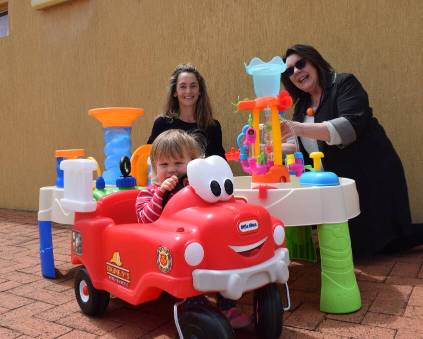 Busselton Toy Library president Brady Van Wyk, Busselton Water chair Helen Shervington and Maya Kearney test out the new toys purchased with the funding. Image Sophie Elliott.