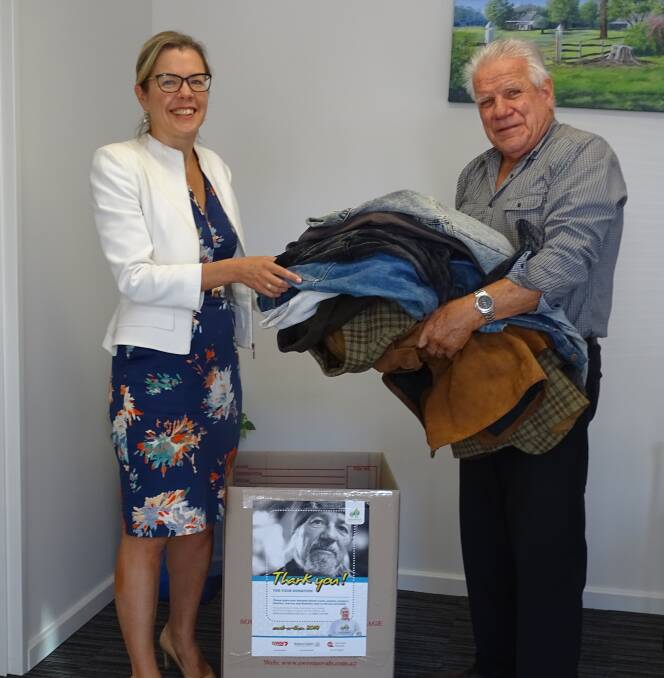 Vasse MLA Libby Mettam receives donations from Rob Griffiths. Image supplied.