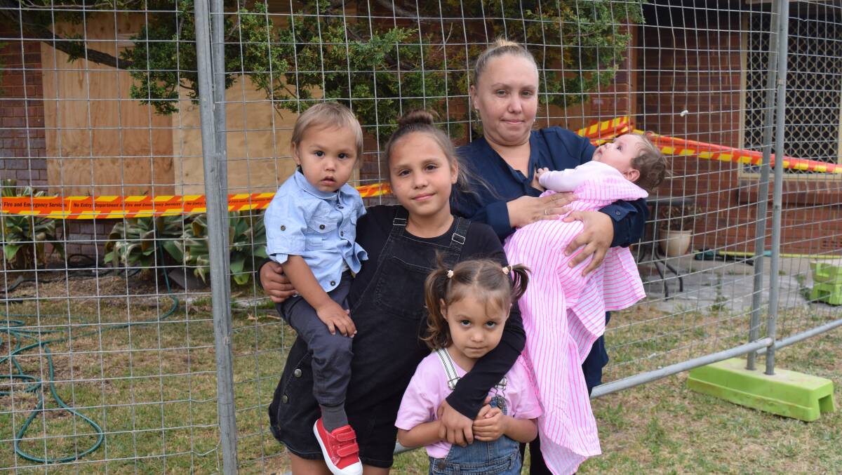 Jerilee Weston with four of her children - baby Mila, toddler Harry, Allie, 9, and Adele, 4 - outside their former property. Image Sophie Elliott.