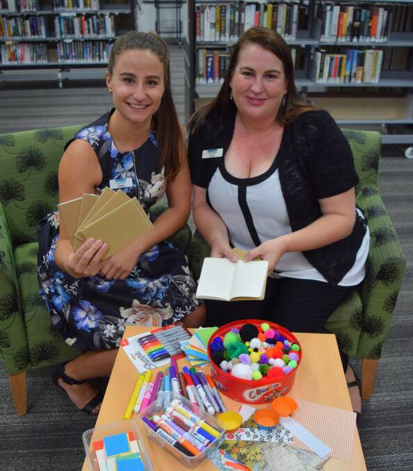 Therese Colman and Penny Crowley from Busselton Library with the blank sketchbooks and decorative materials.