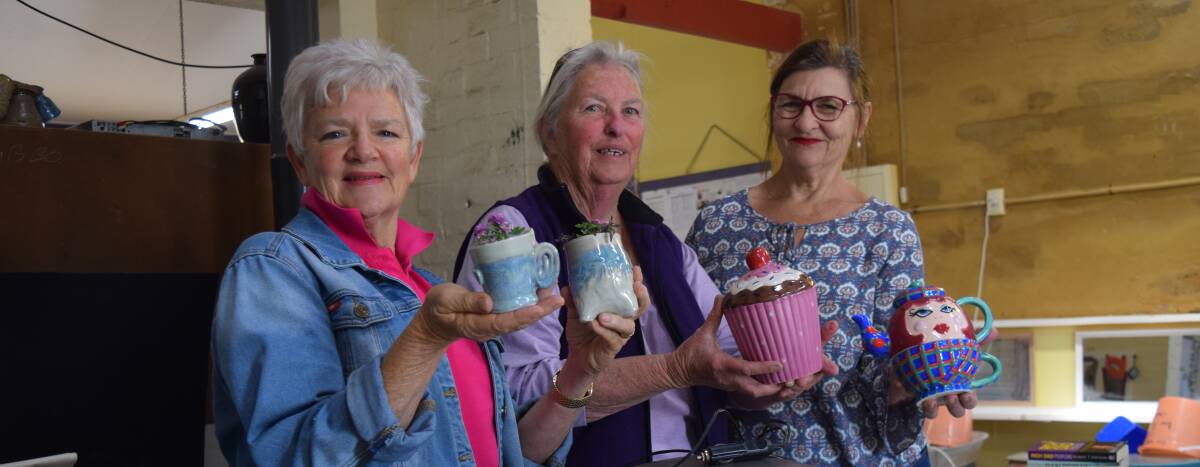 Busselton Pottery Club secretary Jan Roberts, member Cythia Williamson and president Susan Graf with some of the items that will be for sale. Image Sophie Elliott.