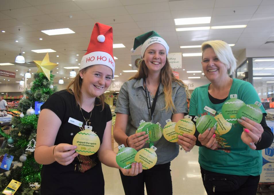 Woolworths Busselton team members Jayda Pountney, Lily Mannion and Anne Briede show off some of the stores OzHarvest Christmas Appeal tokens. Image Sophie Elliott.