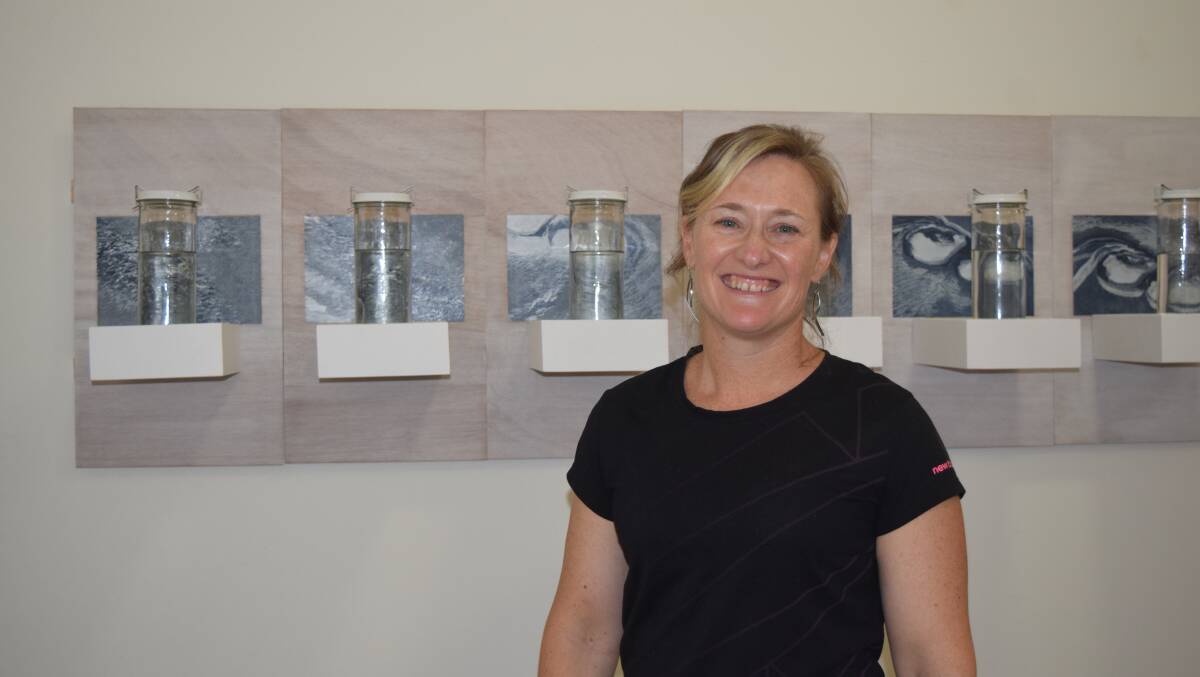 Albany artist Nat Rad with her work, Buoyant, which combines her passion for art and rowing. Image Sophie Elliott.