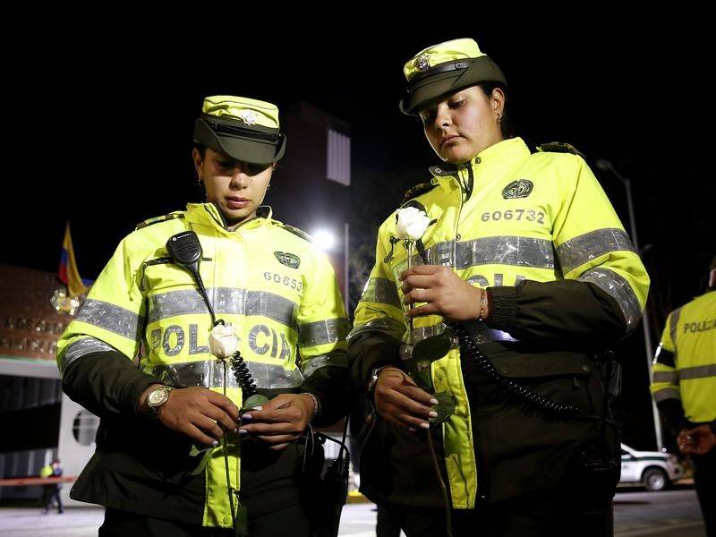 Colombians have gathered at the Bogota police academy where 21 people were killed in a car bombing.