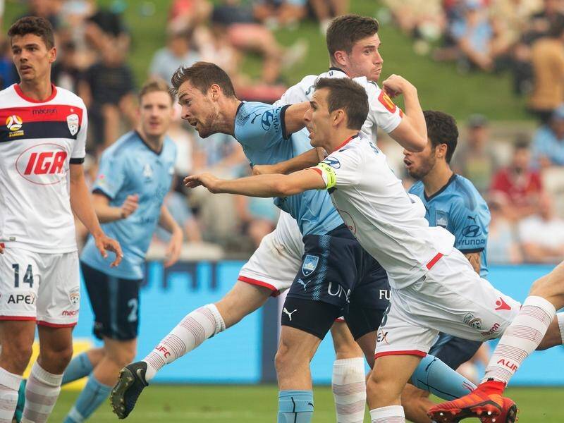 Sydney FC's Jacob Tratt scores with a header against Adelaide United at Jubilee Stadium.
