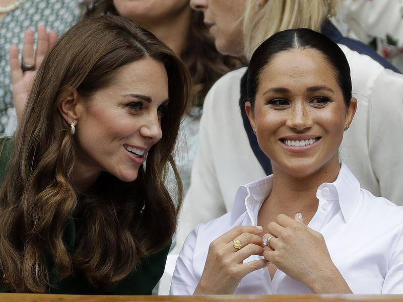 Kate and Meghan were seen smiling and chatting in the royal box at Wimbledon's Centre Court.