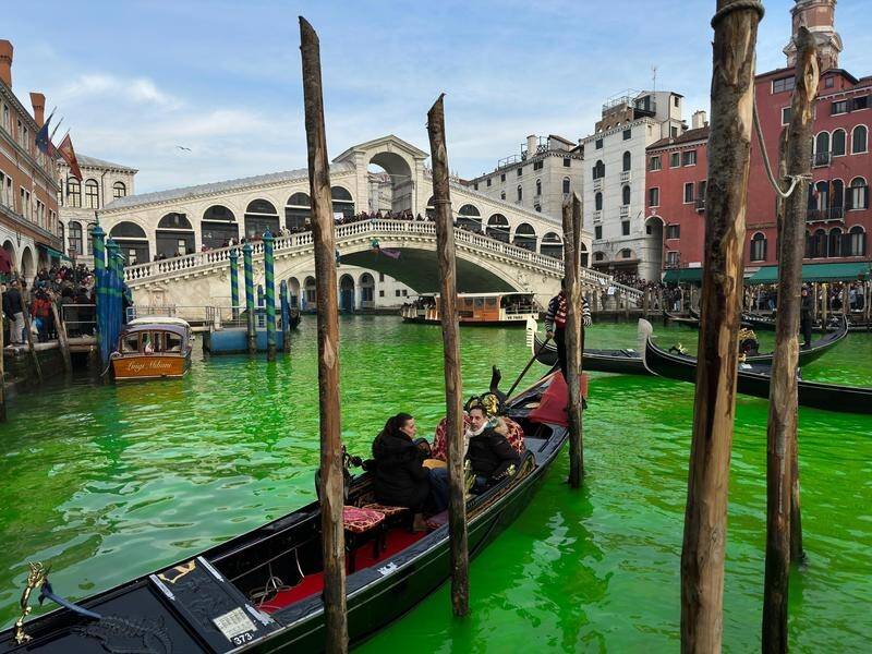 The waters of Canal Grande were turned green by climate activists from Extinction Rebellinon. (EPA PHOTO)