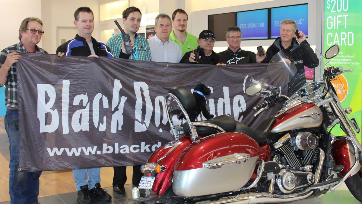 Black Dog Ride members are looking forward to staying connected throughout their state and national rides in August thanks to Telstra’s satellite phone donation. Pictured is Steve McKenzie, Clayton Gordon, Telstra staff member Alec Williams, Telstra area manager Boyd Brown, Telstra staff member Ross Young, Les James, John Lewin and Steve Andrews.