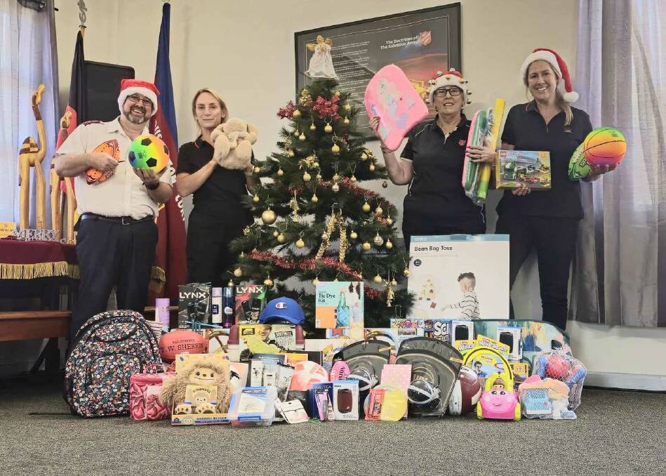 Salvation Army Captain Mark Schatz with Meredith Dixon (Rio Tinto), Dawn McCarthy (Salvation Army) and Claire Somerville-Brown (Rio Tinto) and some of the donations.