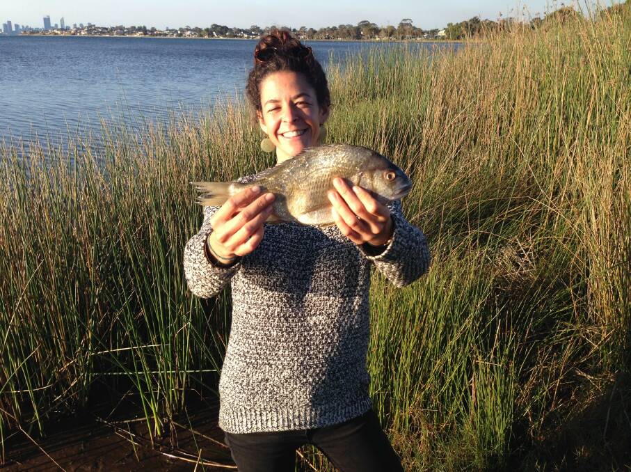 Researcher Clara Obregon with a black bream; the Murdoch Uni study is looking into the popular fish and why anglers love to catch it. 