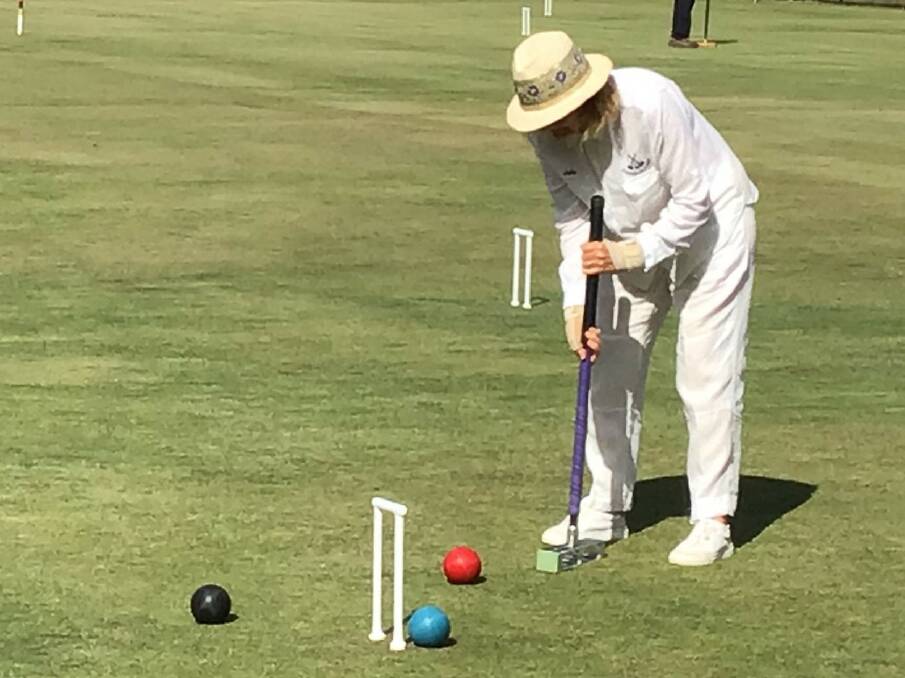 Success rate: Julie Dewar shows how the game of croquet is played. Photo: Supplied.