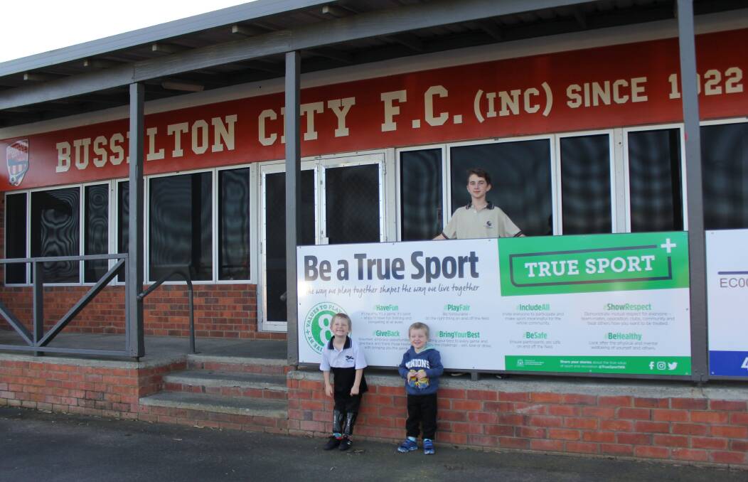 True sports: Busselton City FC  juniors Rieley, Mathew and Jake Cowley with the recently erected True Sport sign at the Churchill Park clubrooms. Photo: supplied.