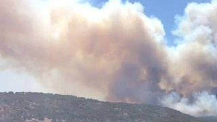 This photo from Channel Ten shows smoke over hills at Baskerville.