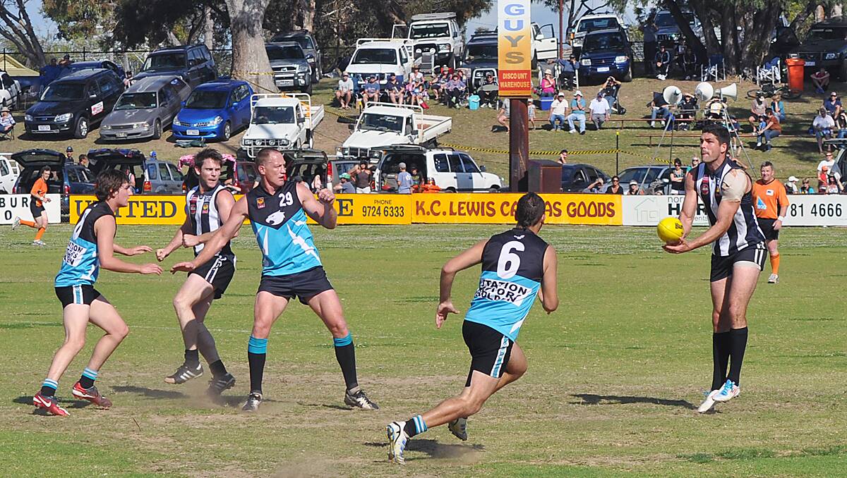 Ruckman Brent Hall looks to offload the ball with a handpass.