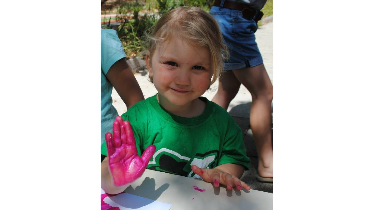  Asta Hardy prepares her handprint to help brighten up the future three-year-old kindy classroom at Balingup Primary School. Photo: Donnybrook-Bridgetown Mail.