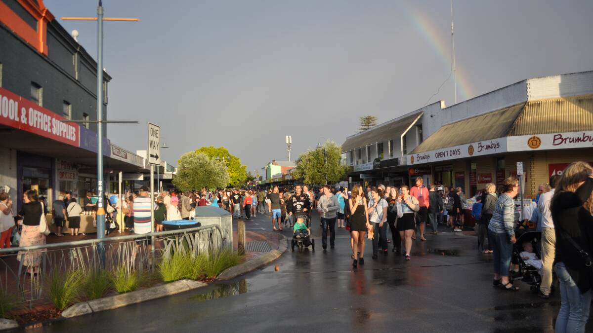 After the rain came a rainbow, and locals took to the street again.