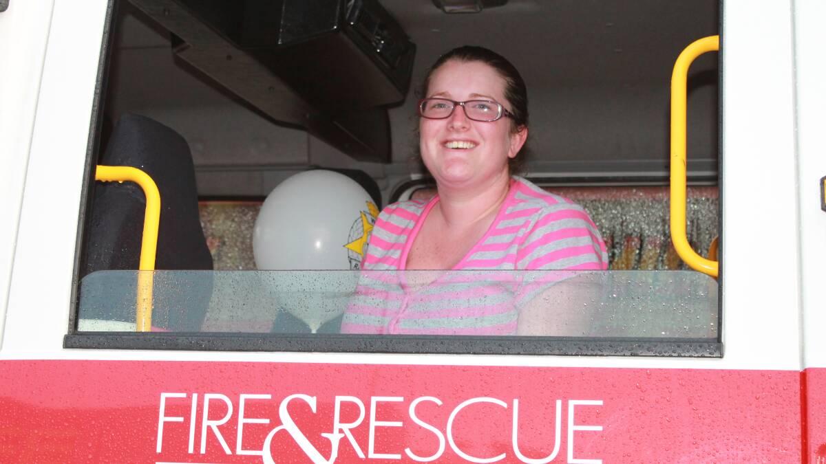 Sarah Crisp scopes out the view from the Fire and Rescue truck.